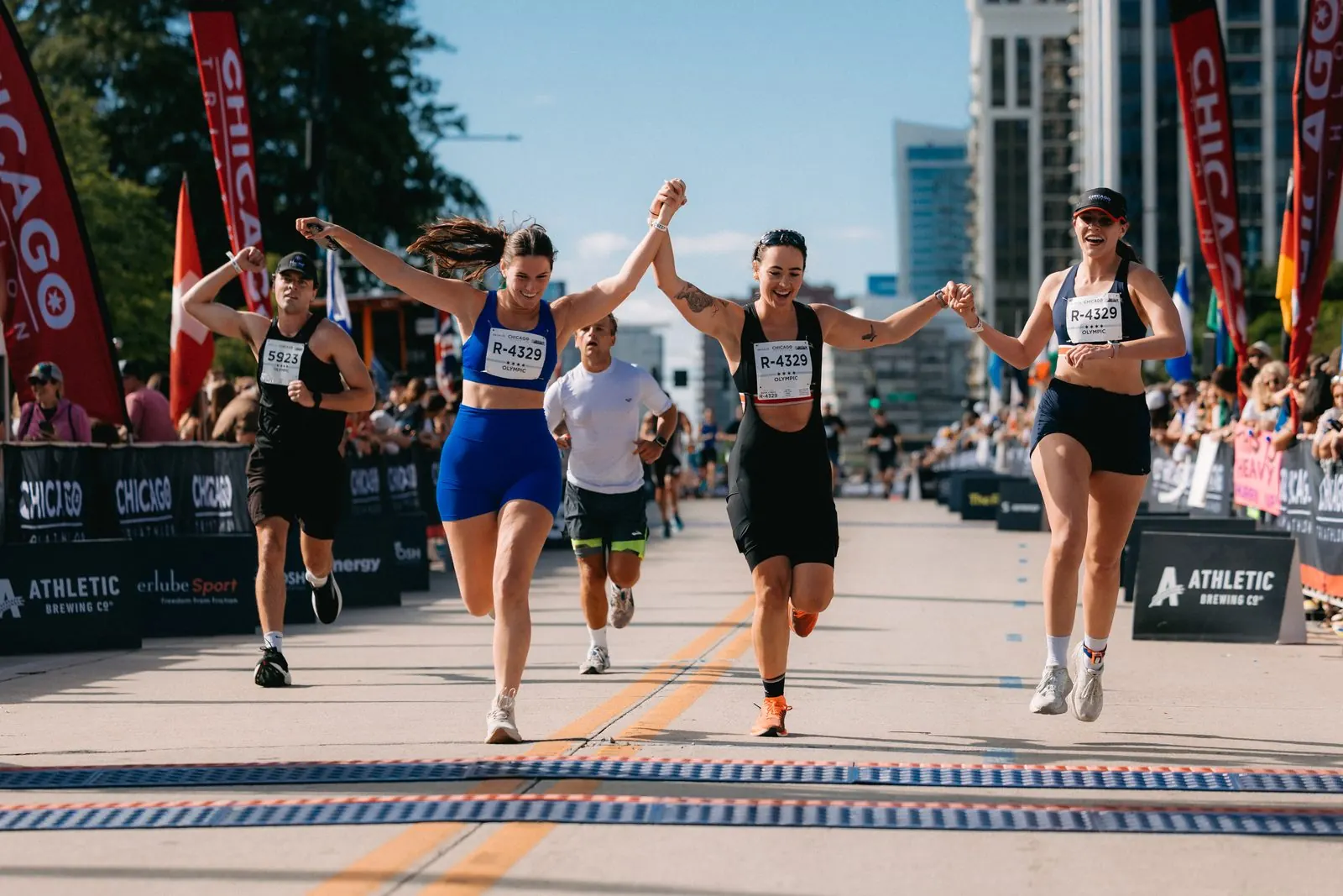 Runners crossing the Chicago Triathlon finish line