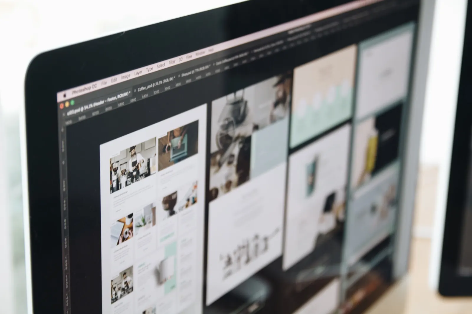 Website layouts being designed on a desktop screen